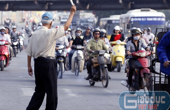 Xin đường ở Hà Nội gần như là điều bất khả thi. Muốn qua đường thì cụ già này phải len lỏi giữa cả rừng xe rất nguy hiểm.